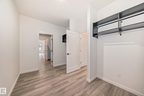 Unfurnished bedroom with light wood-type flooring and baseboards - 1401 Ainslie Wynd, Edmonton, AB - Indoor Photo Showing Other Room