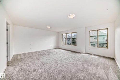 Carpeted empty room with baseboards - 1401 Ainslie Wynd, Edmonton, AB - Indoor Photo Showing Other Room