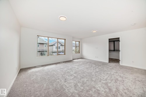 Spare room featuring carpet floors and baseboards - 1401 Ainslie Wynd, Edmonton, AB - Indoor Photo Showing Other Room