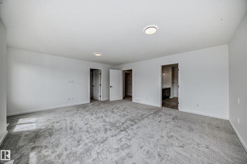 Unfurnished bedroom with carpet and ensuite bathroom - 1401 Ainslie Wynd, Edmonton, AB - Indoor Photo Showing Other Room