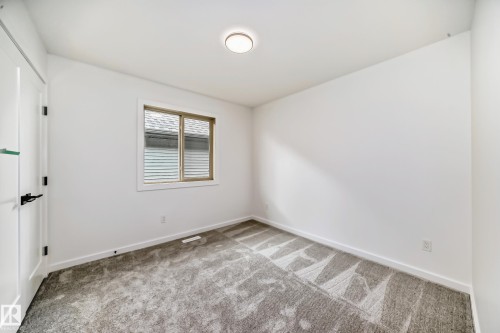 Carpeted spare room featuring baseboards - 1401 Ainslie Wynd, Edmonton, AB - Indoor Photo Showing Other Room