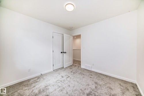 Unfurnished bedroom with carpet floors and baseboards - 1401 Ainslie Wynd, Edmonton, AB - Indoor Photo Showing Other Room