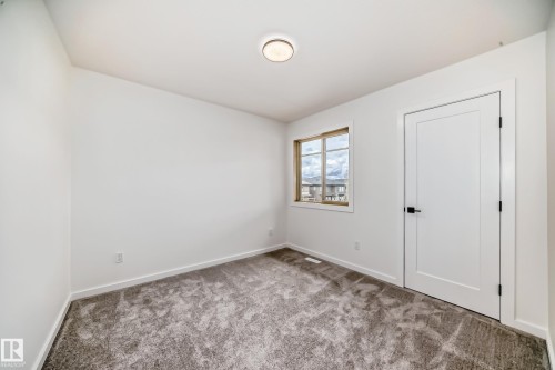 Empty room featuring carpet floors and baseboards - 1401 Ainslie Wynd, Edmonton, AB - Indoor Photo Showing Other Room