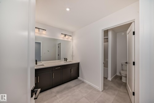 Full bathroom featuring double vanity, tile patterned flooring, recessed lighting, and  shower combination - 1401 Ainslie Wynd, Edmonton, AB - Indoor Photo Showing Bathroom