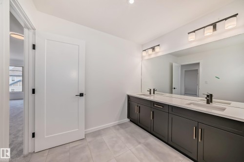 Full bath featuring double vanity and tile patterned floors - 1401 Ainslie Wynd, Edmonton, AB - Indoor Photo Showing Bathroom