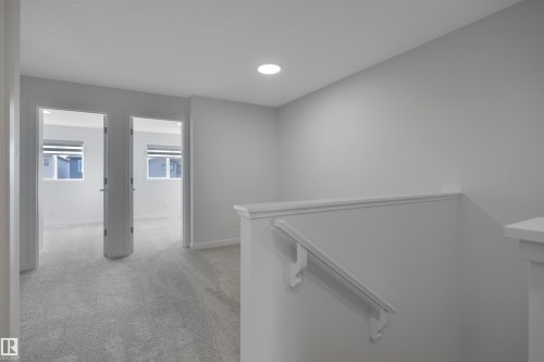 Hallway featuring light colored carpet, an upstairs landing, and recessed lighting - 2275 Alces Drive, Edmonton, AB - Indoor