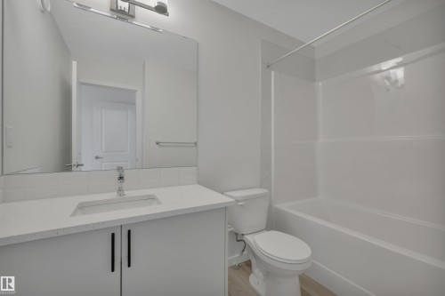 Full bathroom with shower / washtub combination, vanity, and light wood-type flooring - 2275 Alces Drive, Edmonton, AB - Indoor Photo Showing Bathroom