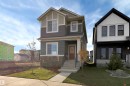 Craftsman-style home featuring a front yard and stone siding - 2275 Alces Drive, Edmonton, AB  - Outdoor With Facade 
