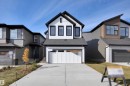 View of front of home featuring board and batten siding, roof with shingles, an attached garage, and concrete driveway - 9104 Elves Loop, Edmonton, AB  - Outdoor With Facade 
