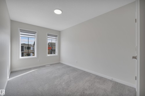 Spare room with carpet and baseboards - 9104 Elves Loop, Edmonton, AB - Indoor Photo Showing Other Room