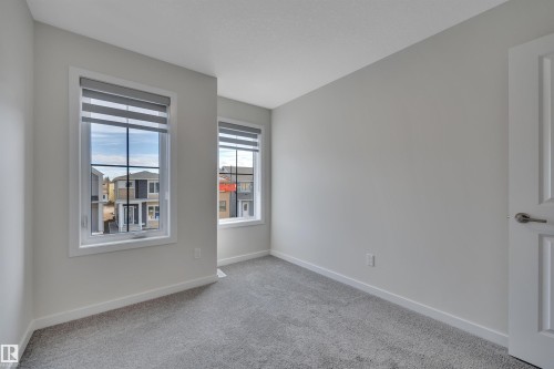 Spare room featuring carpet flooring and baseboards - 9104 Elves Loop, Edmonton, AB - Indoor Photo Showing Other Room