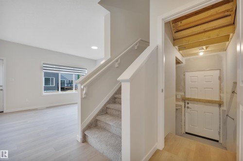 Stairway featuring wood finished floors and recessed lighting - 9104 Elves Loop, Edmonton, AB - Indoor Photo Showing Other Room