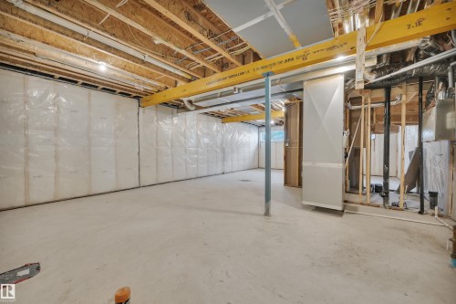 Unfinished basement featuring heating unit - 9104 Elves Loop, Edmonton, AB - Indoor Photo Showing Basement