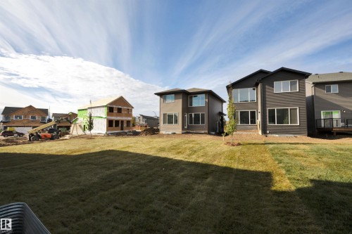 Back of house featuring a lawn and a residential view - 9104 Elves Loop, Edmonton, AB - Outdoor With Facade