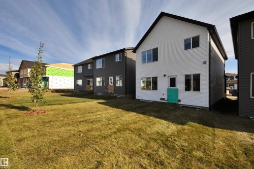 Rear view of house featuring a lawn - 9104 Elves Loop, Edmonton, AB - Outdoor