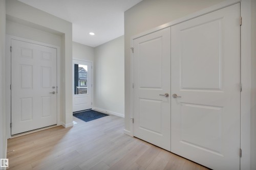 Entrance foyer featuring light wood-style flooring and recessed lighting - 9104 Elves Loop, Edmonton, AB - Indoor Photo Showing Other Room