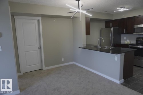 409 5810 Mullen Place, Edmonton, AB - Indoor Photo Showing Kitchen With Double Sink
