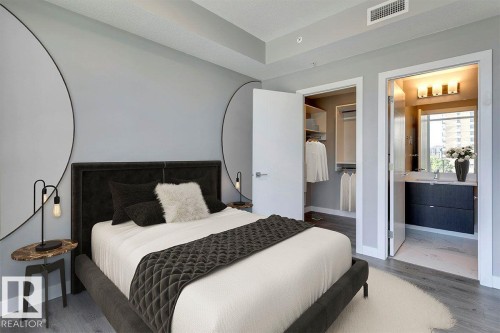 Bedroom featuring wood finished floors and ensuite bathroom - 9922 111 Street, Edmonton, AB - Indoor Photo Showing Bedroom