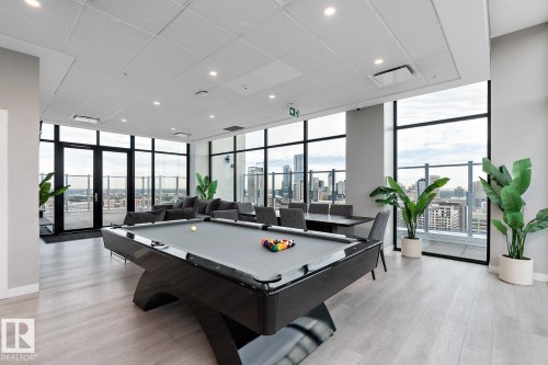 Playroom with floor to ceiling windows, a view of skyline, pool table, healthy amount of natural light, and recessed lighting - 9922 111 Street, Edmonton, AB - Indoor Photo Showing Other Room