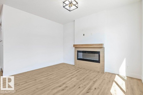 65 Silverstone Drive, Stony Plain, AB - Indoor Photo Showing Living Room With Fireplace