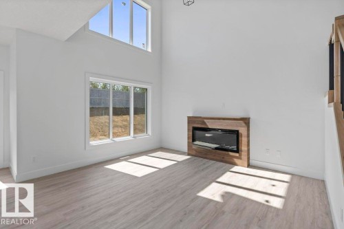 65 Silverstone Drive, Stony Plain, AB - Indoor Photo Showing Living Room With Fireplace
