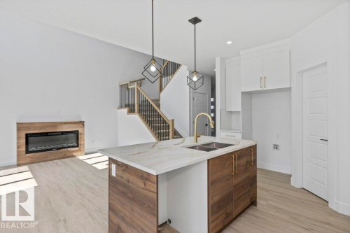 65 Silverstone Drive, Stony Plain, AB - Indoor Photo Showing Kitchen With Fireplace With Double Sink