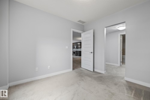 Unfurnished bedroom with carpet and baseboards - 810 5151 Windermere Boulevard, Edmonton, AB - Indoor