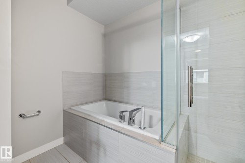 Full bath with a bath and a stall shower - 810 5151 Windermere Boulevard, Edmonton, AB - Indoor Photo Showing Bathroom