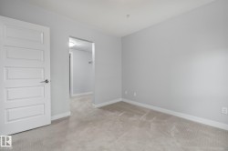 Empty room with carpet floors and baseboards - 