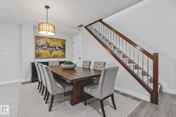 Dining space featuring light wood-style floors and stairs - 