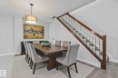 Dining space featuring light wood-style floors and stairs - 810 5151 Windermere Boulevard, Edmonton, AB  - Indoor Photo Showing Dining Room 