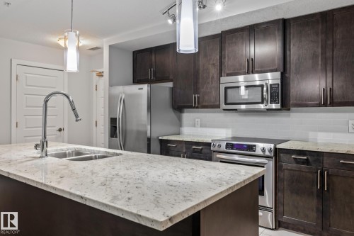 810 5151 Windermere Boulevard, Edmonton, AB - Indoor Photo Showing Kitchen With Stainless Steel Kitchen With Double Sink With Upgraded Kitchen