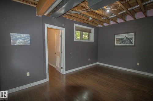 Basement featuring baseboards and dark wood-style floors - 5753 43 Ave, St. Paul Town, AB - Indoor Photo Showing Other Room