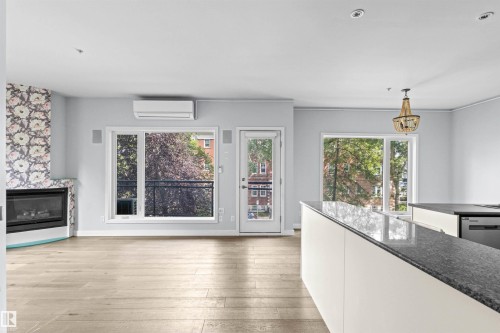 204 11415 100 Avenue, Edmonton, AB - Indoor Photo Showing Living Room With Fireplace