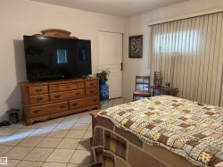 Bedroom with light tile patterned floors - 