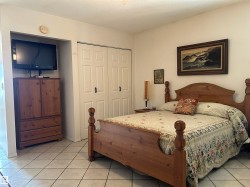 Bedroom featuring light tile patterned floors, a closet, and a textured ceiling - 