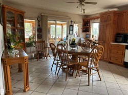 Dining space with light tile patterned floors, healthy amount of natural light, ceiling fan, and a textured ceiling - 