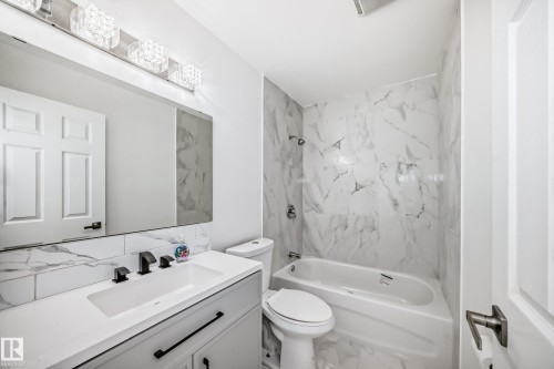 Bathroom with tub / shower combination, vanity, and backsplash - 13116 31 Strret, Edmonton, AB - Indoor Photo Showing Bathroom