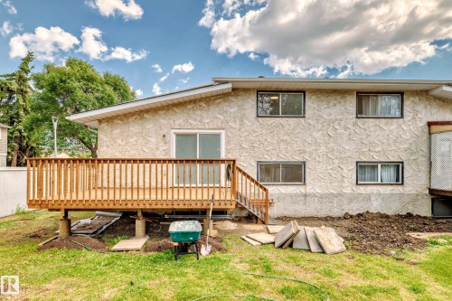 Back of house with a wooden deck, stucco siding, and a lawn - 13116 31 Strret, Edmonton, AB - Outdoor With Deck Patio Veranda