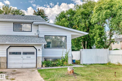 View of front of house featuring a shingled roof, a garage, and concrete driveway - 13116 31 Strret, Edmonton, AB - Outdoor