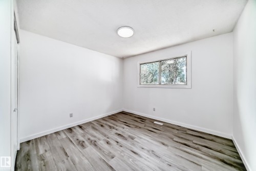 Unfurnished room with light wood finished floors and baseboards - 13116 31 Strret, Edmonton, AB - Indoor Photo Showing Other Room
