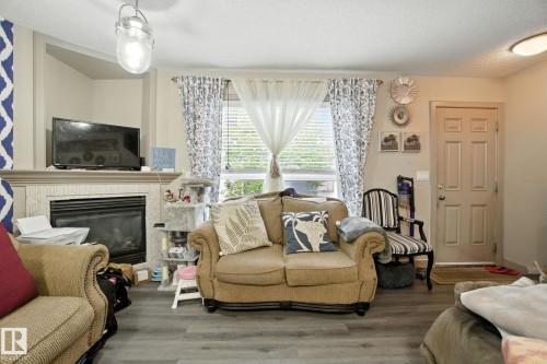 8 1820 34 Avenue, Edmonton, AB - Indoor Photo Showing Living Room With Fireplace
