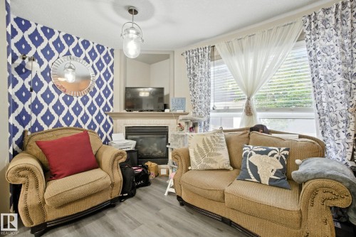 8 1820 34 Avenue, Edmonton, AB - Indoor Photo Showing Living Room With Fireplace