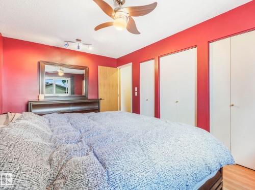 Bedroom featuring multiple closets, ceiling fan, and wood finished floors - 3608 15 Avenue, Edmonton, AB - Indoor Photo Showing Bedroom