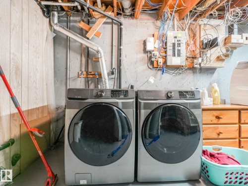 Generous Laundry Room featuring independent washer and dryer and electric panel - 3608 15 Avenue, Edmonton, AB - Indoor Photo Showing Laundry Room