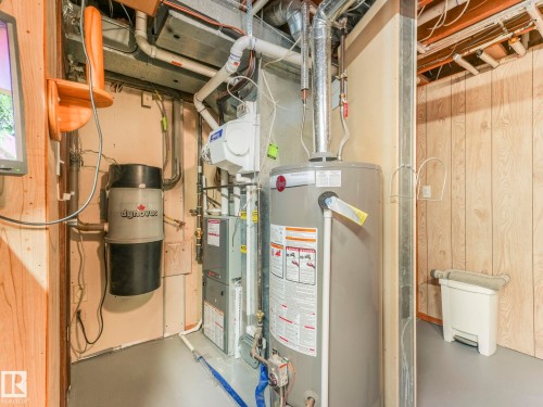 Utility room with gas water heater and a central vacuum unit - 3608 15 Avenue, Edmonton, AB - Indoor Photo Showing Basement