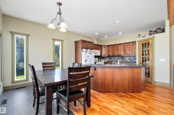 Dining room with recessed lighting, a chandelier, and light wood-type flooring - 