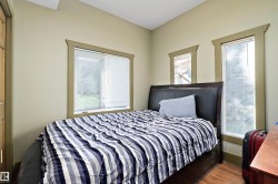 Bedroom with wood finished floors and baseboards - 