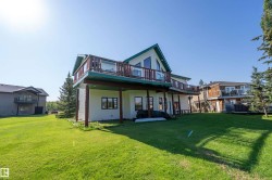 Back of property with a yard, a patio, and a deck - 