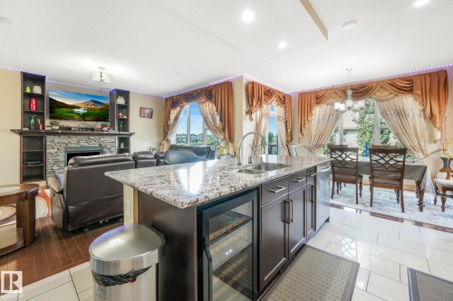 1238 Secord Landing Landing, Edmonton, AB - Indoor Photo Showing Kitchen With Fireplace With Double Sink